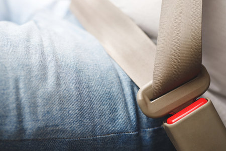 Close Up of people man hand fastening seat safety belt in car for safety before driving on the road. concept transport travel. soft focus.の写真素材
