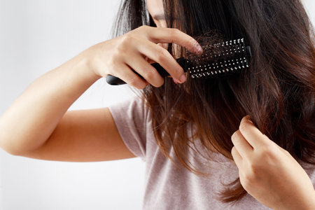 Rear view young woman worried about Hair loss problem, hormonal disbalance, stress concept.の写真素材