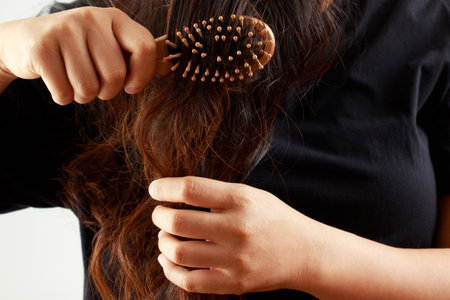 young woman worried about Hair loss problem after comb in hand. problem hormonal disbalance, stress...