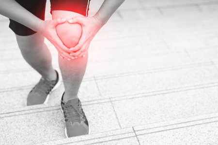 Runner touching painful twisted or broken. Athlete training, running up and down stairs accident. Sport sprained sprain cause injury knee. and pain with leg bones.の写真素材