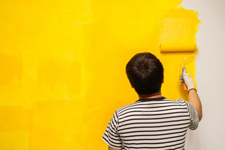 Painter is painting the interior wall yellowの写真素材