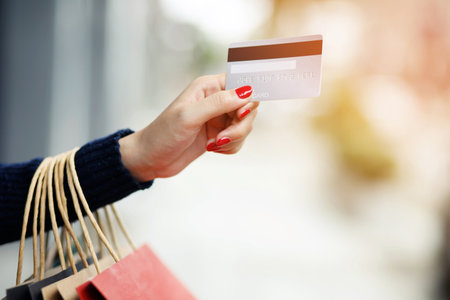 woman person holding a wallet in the hand of a  take credit card out of pocket. Cost control expenses shopping in concept. Leave space to write descriptive text.の写真素材