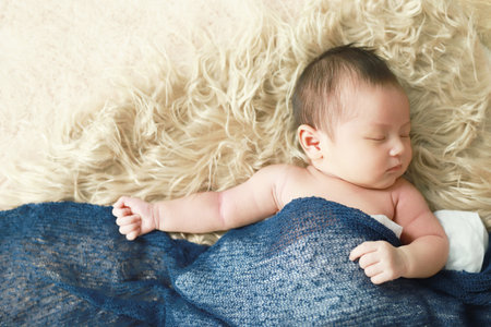 The newborn is sleeping with his motherの写真素材