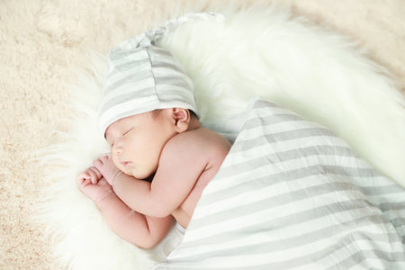 The newborn is sleeping with his motherの写真素材