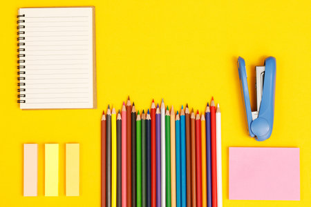 Top view notebooks and accessories studying in the library at school yellow background idea educationの写真素材