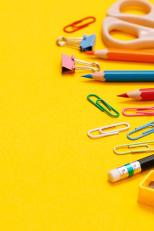 Top view notebooks and accessories studying in the library at school yellow background idea educationの写真素材