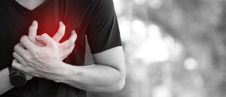 Man having chest pain - heart attack outdoors. or Heavy exercise causes the body to shocks heart diseaseの写真素材