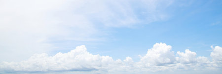 Beautiful clear blue sky background with tiny plain white cloud on morning time rays sunlight. space for text. soft focus.の写真素材