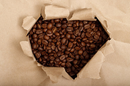 Freshly roasted coffee beans in a cupの写真素材