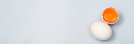 Top view egg yolk and egg white high protein good for body blue background.の写真素材