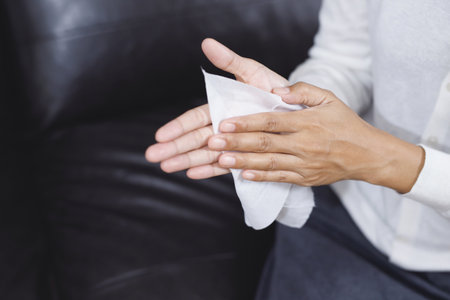 woman using tissue paper Clean your hands to remove germs.の写真素材