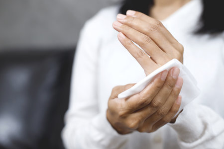 woman using tissue paper Clean your hands to remove germs.の写真素材