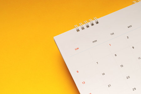 close up top view calendar schedule to make appointment meeting or manage timetable each day lay on yellow background for planning work and travel concept.の写真素材