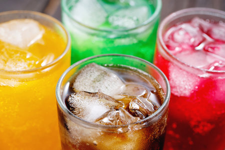 Soft drinks and fruit juice mixed with soda high in sugar have a negative effect on physical healthの写真素材