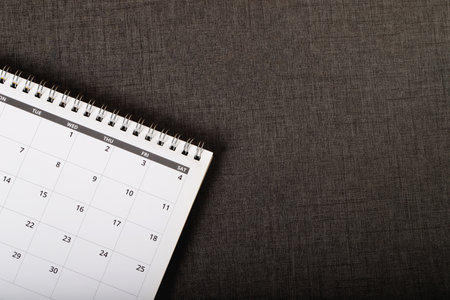 close up top view calendar month schedule to make appointment meeting or manage timetable each day lay on wooden background for planning work and travel concept. banner copy spaceの写真素材