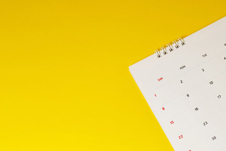 close up top view calendar 2020 month december end of the year schedule to make appointment meeting or manage timetable each day lay on yellow background for planning work and travel concept.の写真素材