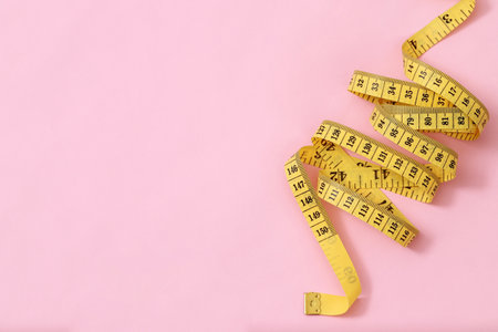 tape measure for obese people on a pink background soft focusの写真素材