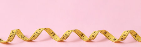tape measure for obese people on a pink background soft focusの写真素材