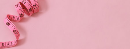 tape measure for obese people on a pink background soft focusの写真素材