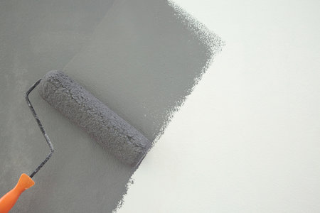Roller Brush Painting, Worker painting on surface wall  Painting apartment, renovating with grey...