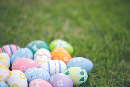 Collection of colorful easter eggs on green grass to celebrate Easter or spring.