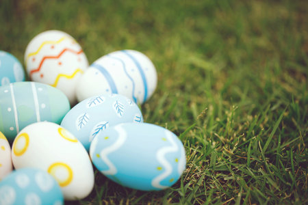 Collection of colorful easter eggs on green grass to celebrate Easter or spring.の写真素材