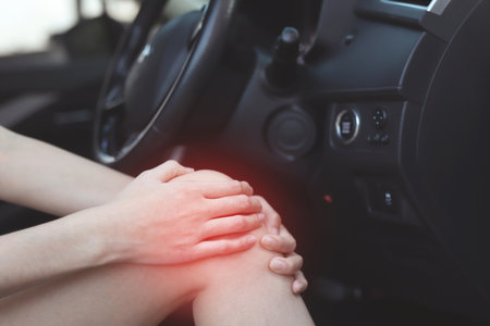 Woman has knee pain in the carの写真素材