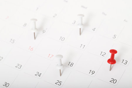mark the event day with a pin. Thumbtack in calendar concept for busy timeline organize schedule,appointment meeting reminder. planning business meeting or travel holiday planning concept. soft focusの写真素材