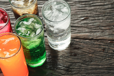 Soft drinks and fruit juice mixed with soda high in sugar have a negative effect on physical healthの写真素材