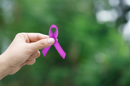 woman with purple ribbon For patients with breast and cervical cancerの写真素材