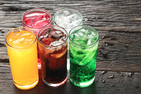 Soft drinks and fruit juice mixed with soda high in sugar have a negative effect on physical healthの写真素材