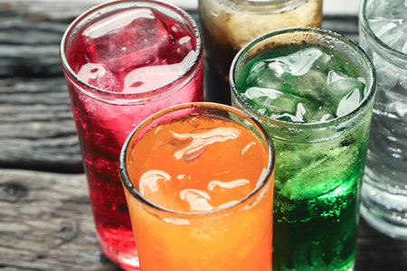 Soft drinks and fruit juice mixed with soda high in sugar have a negative effect on physical healthの写真素材