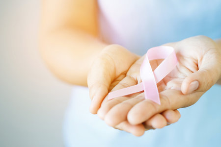 woman with Pink ribbon for patients with breast and cervical cancerの写真素材