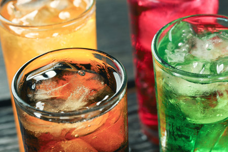 Soft drinks and fruit juice mixed with soda high in sugar have a negative effect on physical healthの写真素材
