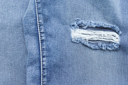 Tear marks on denim jeans vintage fashion texture.background