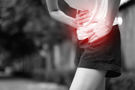 Woman having a stomachache, or menstruation pain. suffering from abdominal. Menstrual cramps. Healthcare and medical, gynecology concept.の写真素材