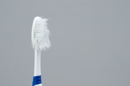 A damaged toothbrush is a breeding ground for germs and bacteria, which can cause swollen gums.の写真素材