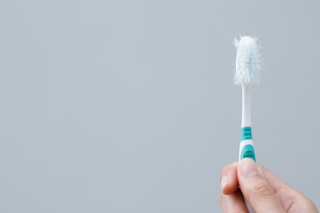 A damaged toothbrush is a breeding ground for germs and bacteria, which can cause swollen gums.の写真素材