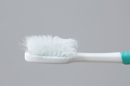 A damaged toothbrush is a breeding ground for germs and bacteria, which can cause swollen gums.の写真素材