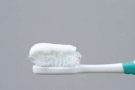 A damaged toothbrush is a breeding ground for germs and bacteria, which can cause swollen gums.の写真素材