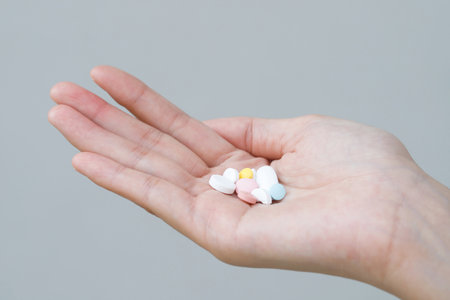 close up hand man taking multiple colors pills in hand. Stop drug use Taking Medication health care...