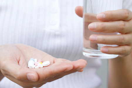 close up hand man taking multiple colors pills in hand. Stop drug use Taking Medication health care medical conceptの写真素材