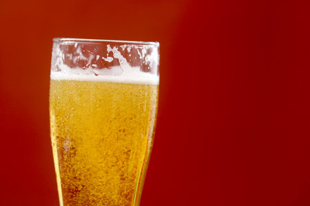 Cold beer with foam in a glass, ready to drink.の写真素材