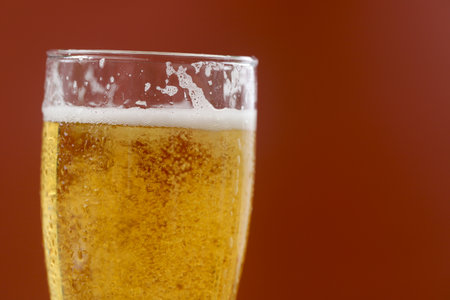 Cold beer with foam in a glass, ready to drink.の写真素材