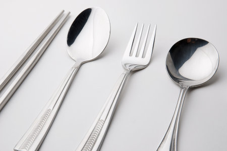 chopsticks spoon and fork stainless steel kitchen utensil isolatedの写真素材