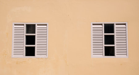 old window on  yellow wall at Bang Pa In Palace Ayutthaya province Thailandの写真素材