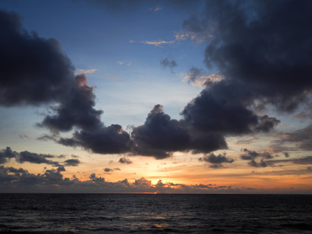 Seascape sunset with black cloud at Nai Yang Beach, Phuket, Thailandの写真素材
