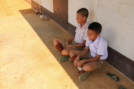 LOPBURI, THAILAND - FEBBRUARY 25, 2014 : a group of happy unidentified Thai children sitting on the ground with smile on faces.のeditorial素材