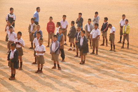 LOPBURI, THAILAND - FEBBRUARY 25, 2014 : Thai students prayer while standing in a line With the sunlight in the morning at schoolのeditorial素材