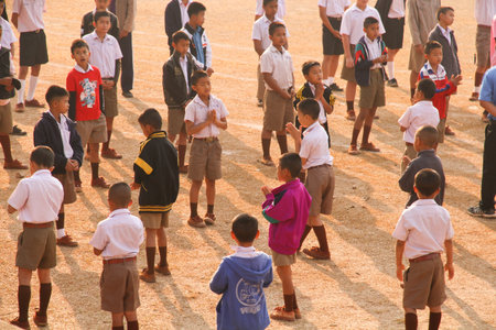 LOPBURI, THAILAND - FEBBRUARY 25, 2014 : Thai students prayer while standing in a line With the sunlight in the morning at schoolのeditorial素材
